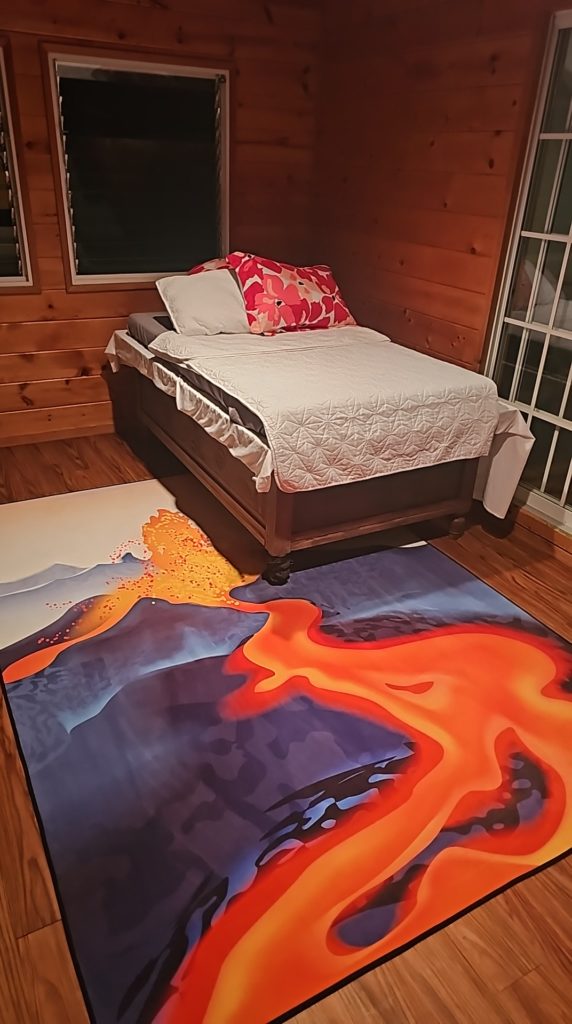 Meditation Room. Peace and tranquility abound in the meditation room with its lava rug and buddah day bed. Numerous windows reveal the view of native hapuu ferns blowing in the breeze. The meditation room is located on the south end of the home on the lower floor.